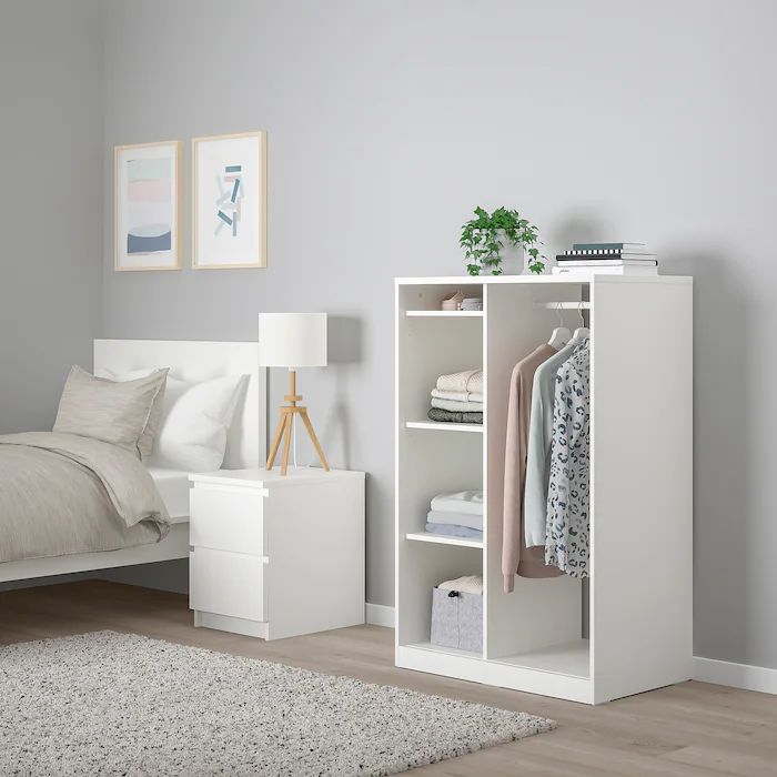 White open baby wardrobe with hanging rail and shelves