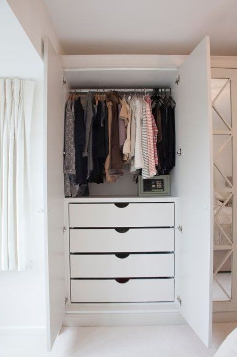 White two-door baby wardrobe with hanging rail and four drawers