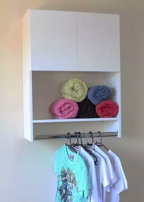 Wall-mounted white baby wardrobe cabinet with shelf and hanging rail