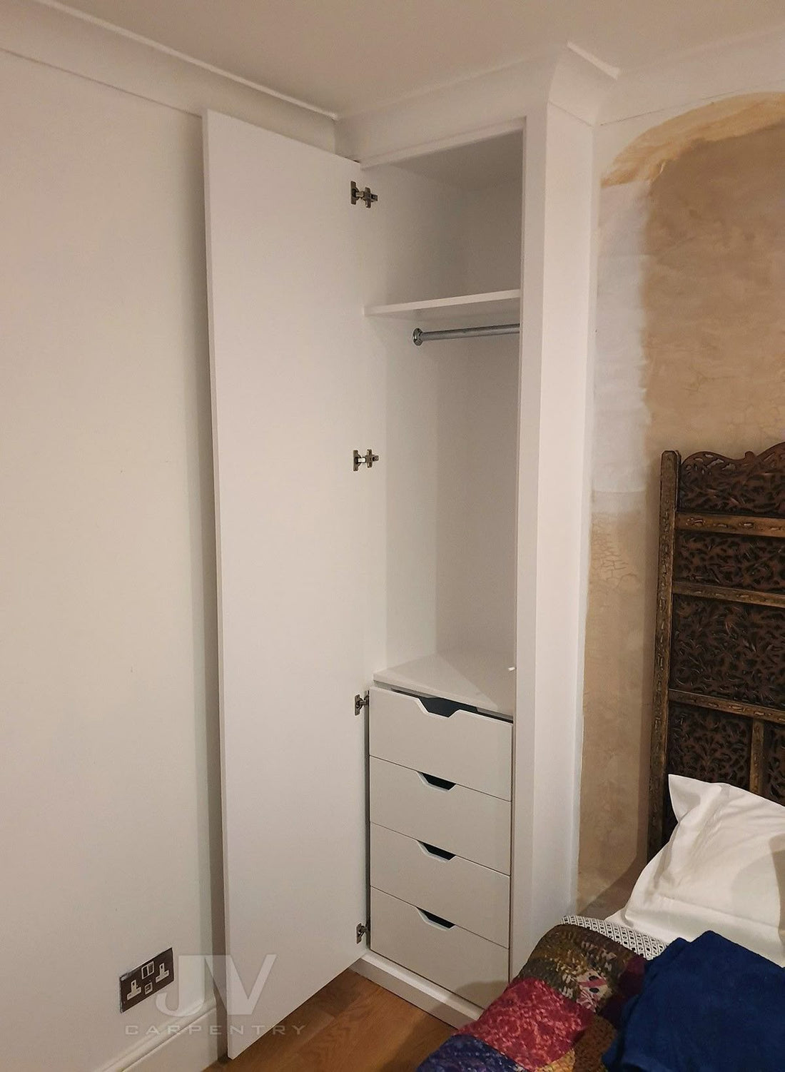 Tall slim white baby wardrobe with hanging rail and four drawers